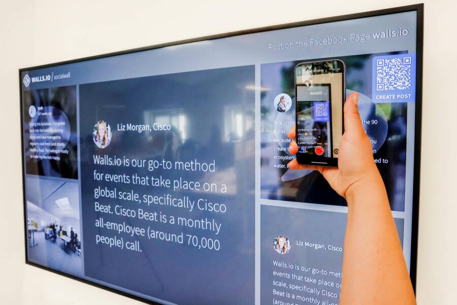 image of a hand holding a smartphone scanning a QR code