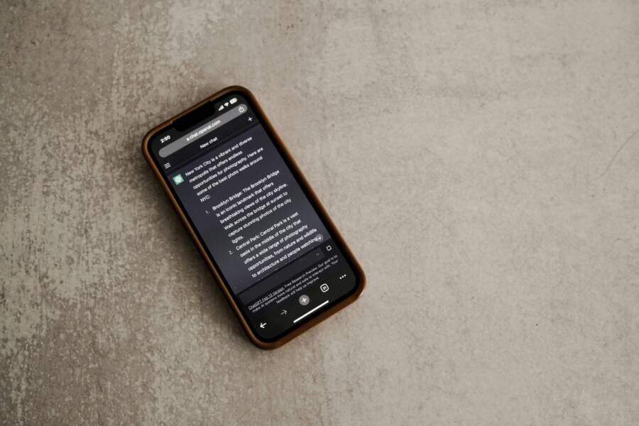 Fix WhatsApp Ban: Restore Access If This Phone Number is Banned A smartphone displaying a messaging app screen, placed on a textured surface.