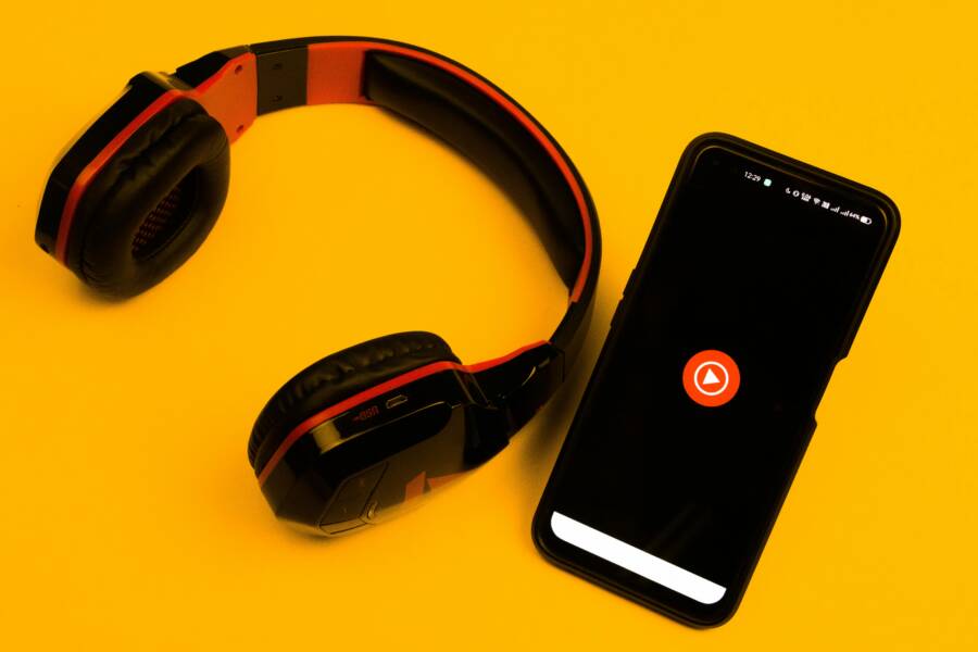 Headphones Not Appearing on Phone: Quick Fixes for Android and iPhone Wireless headphones and smartphone with play icon on a vibrant yellow background