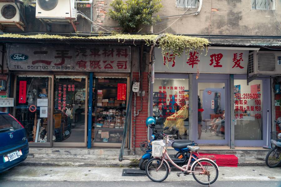 A charming street in Taipei showcasing vintage shops and a bicycle, depicting local urban life