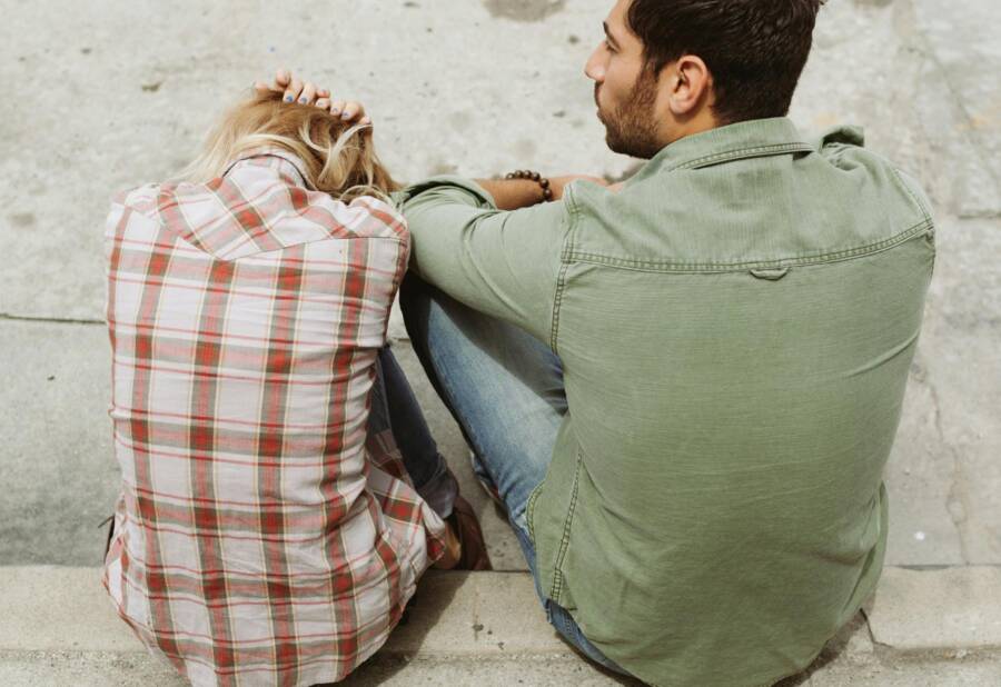 A couple in a tense conversation on the street