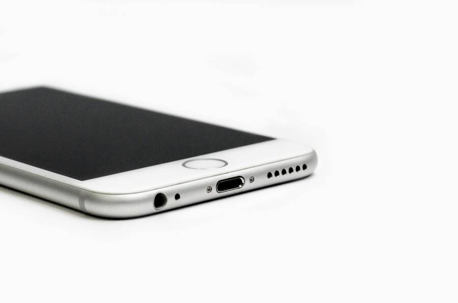 Minimalist image of a sleek smartphone with focus on the bottom edge and ports.