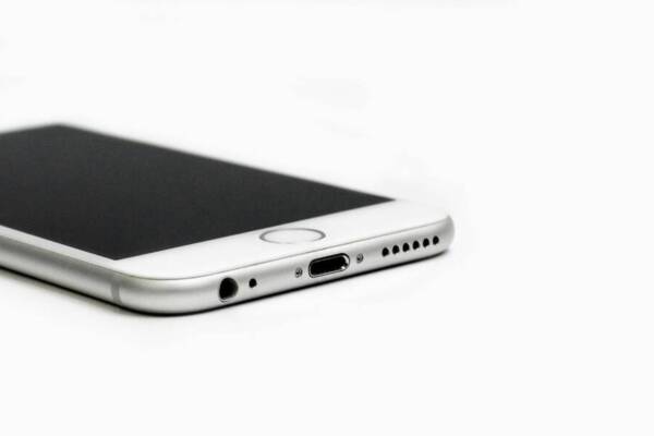 Minimalist image of a sleek smartphone with focus on the bottom edge and ports