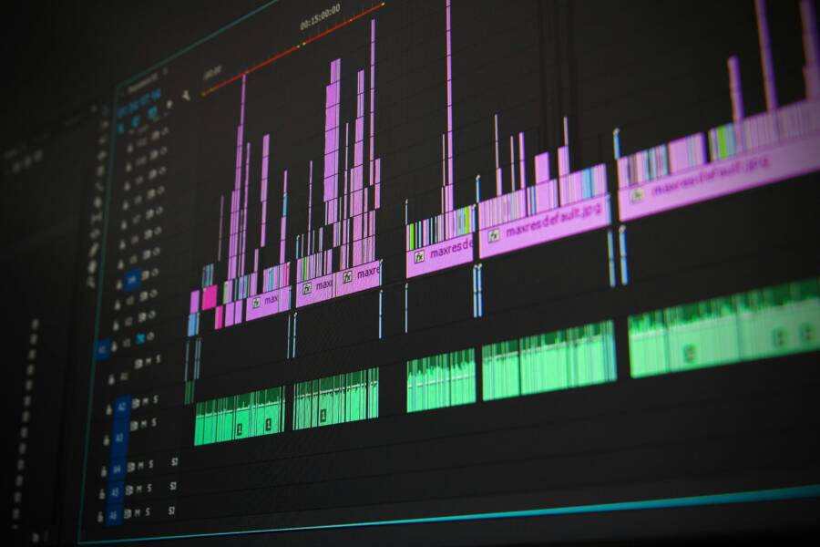Close-up of a professional audio and video editing software interface with waveform displays