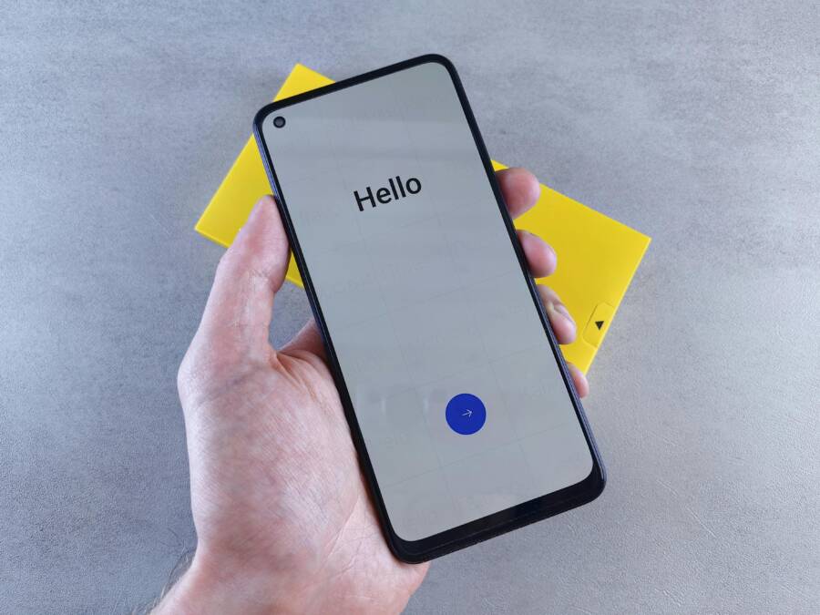 A hand holding a smartphone displaying