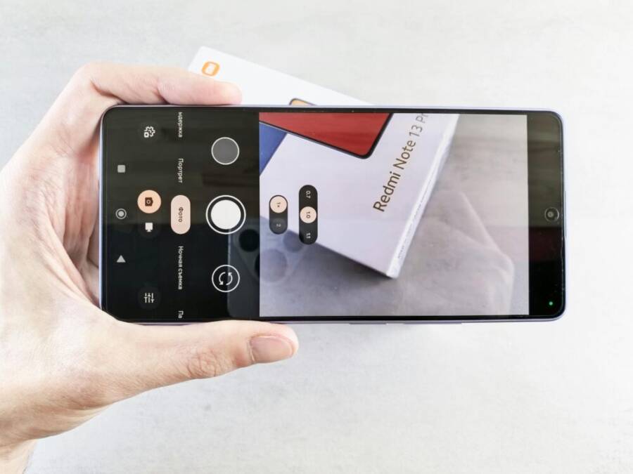 Close-up of a smartphone camera app focusing on a Redmi Note 13 Pro box