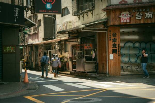 Urban street in Taipei, Taiwan with people walking and traditional shops