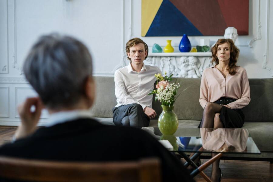 A couple consulting with a therapist in a modern studio setting