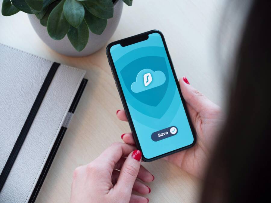Woman using a secure mobile app, showcasing data encryption on a smartphone