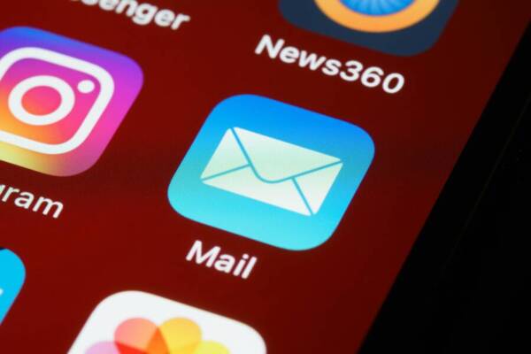 Macro shot of smartphone screen displaying various app icons including Mail and Instagram