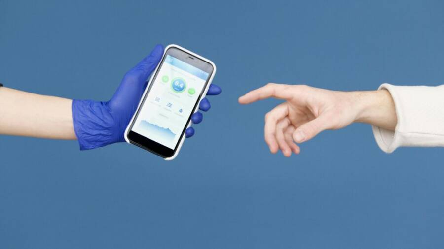 Conceptual image of hands reaching for smartphone with health app on blue background