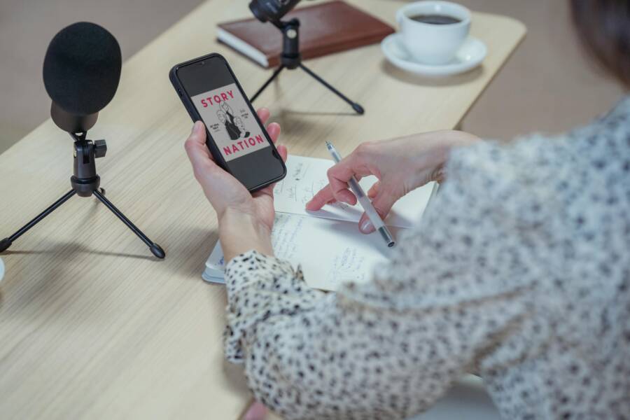 A smartphone with a desk setup for recording, microphone nearby