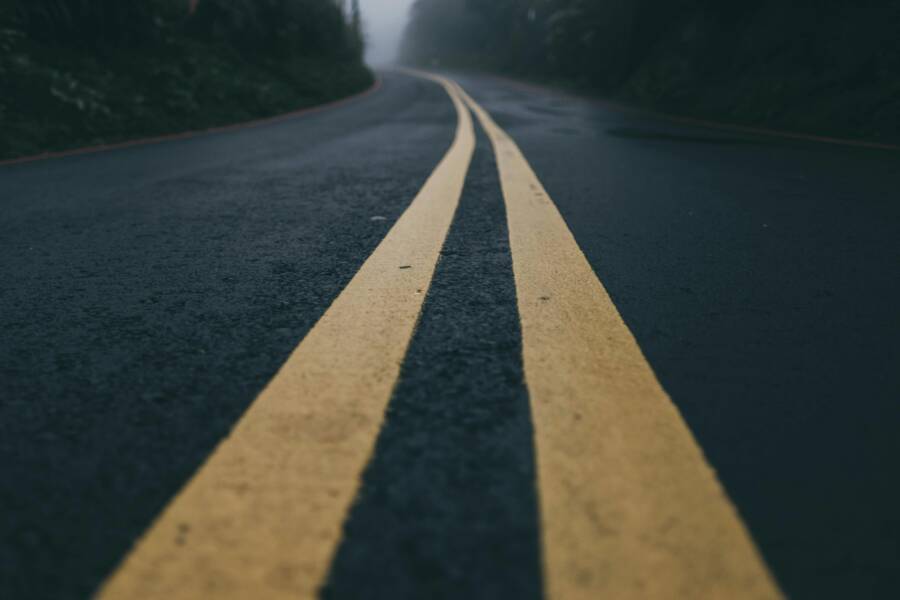 Foggy asphalt road with striking yellow lines in Taiwan