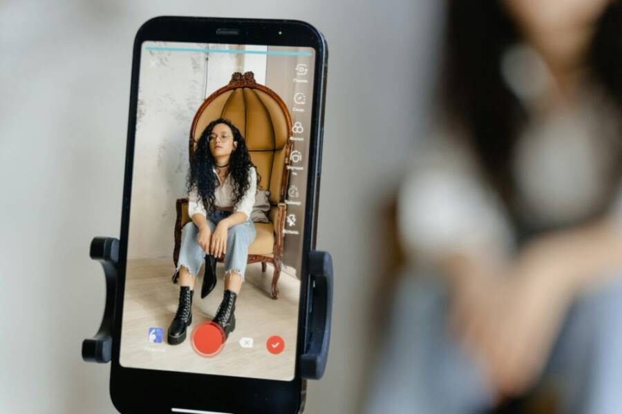image of a creator filming on a smartphone in a clean setup