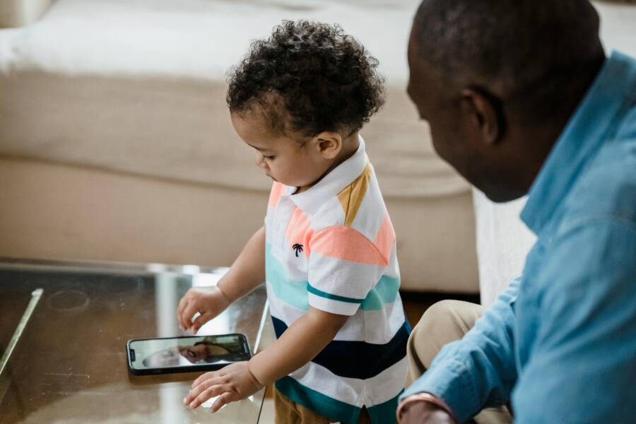 image of a family using a phone together